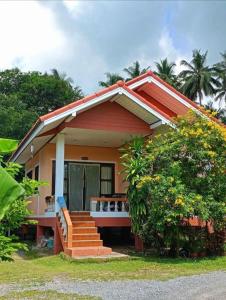 una pequeña casa con una escalera delante en Green Heaven Bungalow 1, en Nathon Bay