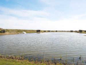 a large body of water with a bridge in the background at 18 person holiday home in Ringkøbing in Ringkøbing