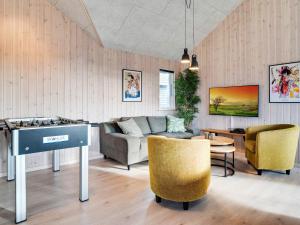 a living room with a couch and a table and chairs at 5 star holiday home in Ringkøbing in Ringkøbing
