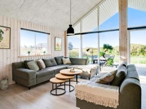 a living room with two couches and a table at 5 star holiday home in Ringkøbing in Ringkøbing