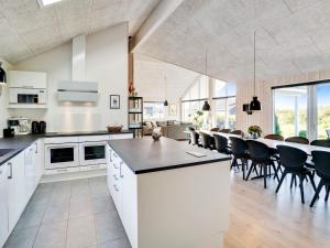 a kitchen and dining room with a table and chairs at 5 star holiday home in Ringkøbing in Ringkøbing