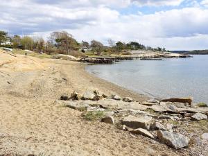 a beach with rocks and a body of water at 6 person holiday home in STRÖMSTAD-By Traum in Strömstad