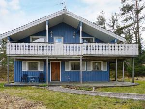 a blue house with a balcony on top of it at 6 person holiday home in STRÖMSTAD-By Traum in Strömstad