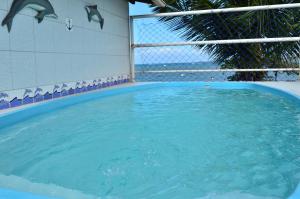 a large pool of water with dolphins in it at Pousada Caravelas in Guarapari