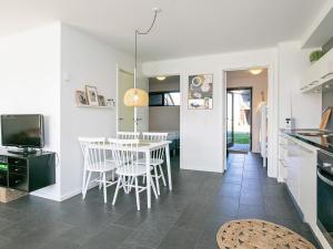 a kitchen and dining room with a table and chairs at 5 star holiday home in Bogense in Bogense