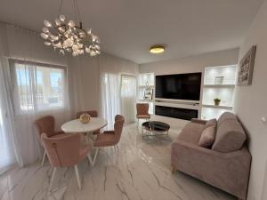 a living room with a couch and a table at Vila Sunset in Kaštela