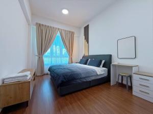 a bedroom with a bed and a desk and a window at Sri Indah The Eleventh 5pax in Sandakan +15 photos