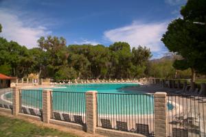 a swimming pool with a fence around it at Soledad Canyon Wheelchair Accessible Cottage 16 in Ravenna