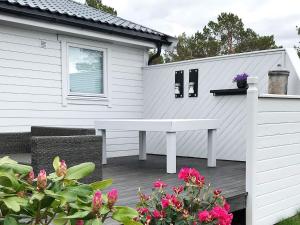 a white bench sitting on a deck next to a house at 6 person holiday home in Aure-By Traum in Aure