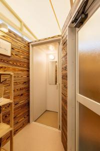 a hallway with a wall of wood paneling at Fukuoka Airport 6 in Shime