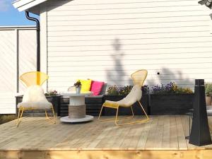 two chairs and a table on a patio at 6 person holiday home in Aure-By Traum in Aure