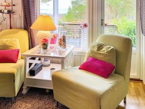 a living room with two chairs and a table with a lamp at 4 star holiday home in Aure in Aure