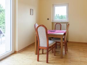 a dining room table with chairs and a pink table cloth at Villa Hochwald Familienhaus in Geisfeld
