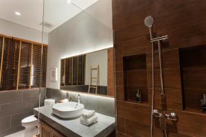 a bathroom with a sink and a shower at Renjana Villas in Ubud +65 photos