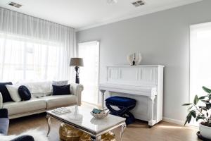 a living room with a couch and a fireplace at Spacious Hamptons-style home with heated pool in Saint Leonards