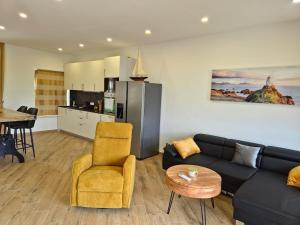 a living room with a couch and a table and a kitchen at New Villa Penelopa in Babino Polje
