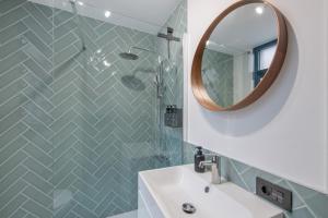 a bathroom with a sink and a mirror at Naos Suite in Puerto Naos +20 photos