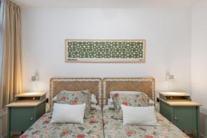 a bedroom with two twin beds and two night stands at Naos Suite in Puerto Naos