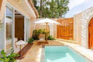 a house with a swimming pool and an umbrella at La FaVilla in Bandung