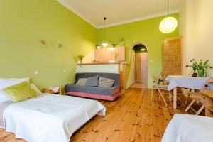 a bedroom with a bed and a couch and a table at Krakow Townhouse in Kraków
