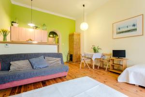 a living room with a couch and a table at Krakow Townhouse in Kraków