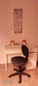 a white desk with a black chair in front of it at Goldstück im Grünen in Bad Schonborn