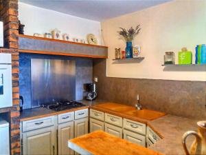 a kitchen with a sink and a stove top oven at Montaigu Countryside Stay in Montaigu-les-Bois