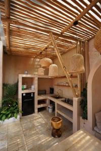 a kitchen with wooden ceilings and a sink and a stove at La FaVilla in Bandung