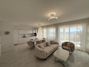 a living room with a couch and a table at Vila Sunset in Kaštela