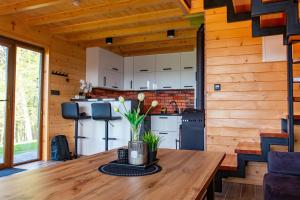 a kitchen in a log cabin with a wooden table at Ranczo pod laskiem 