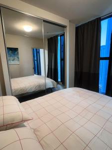 a bedroom with a bed and a large mirror at Melbourne Double Cozy in Melbourne +13 photos