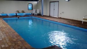 uma grande piscina com água azul num quarto em Magdala Motor Lodge & Lakeside Restaurant em Stawell