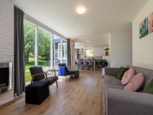 a living room with a couch and a table at Holiday Home near Veerse Meer Lake Wolphaartsdijk in Wolphaartsdijk