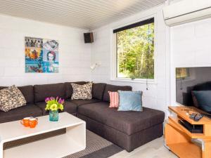 a living room with a couch and a tv at 4 star holiday home in Fur in Fur