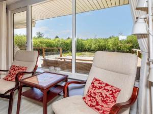 a screened in porch with two chairs and a table at 4 star holiday home in Fur in Fur +38 photos