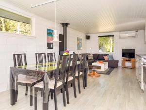 a dining room and living room with a table and chairs at 4 star holiday home in Fur in Fur