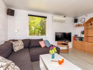 a living room with a couch and a tv at 4 star holiday home in Fur in Fur