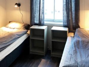 a bedroom with two twin beds and a window at 6 person holiday home in Kverva in Dyrvik