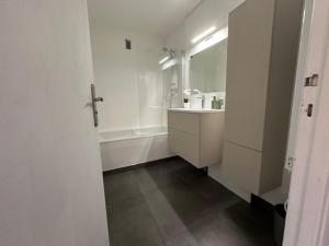 a bathroom with a tub and a sink and a mirror at Bright 1Bedroom Apartment, Steps to Juan les Pins Beach in Antibes +43 photos