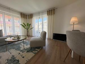 a living room with a couch and a table at Bright 1Bedroom Apartment, Steps to Juan les Pins Beach in Antibes