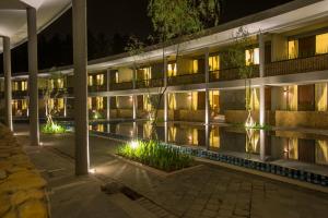 an exterior view of a building at night at Hotel Neo+ Green Savana Sentul City in Bogor