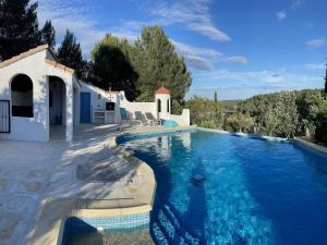 a swimming pool in front of a villa at Modern villa with private pool in Pouzols-Minervois