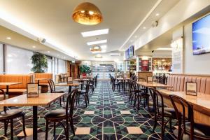 a dining room with tables and chairs in a restaurant at Kingsgrove Hotel in Sydney