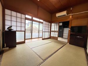 a large room with windows and a television and a room with at ELM On The Beach in Kitaibaraki