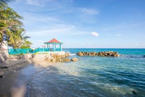 a beach with a gazebo and the ocean at Chrisanns Paradise Suite by the Ocean - Apt#9 in Ocho Rios