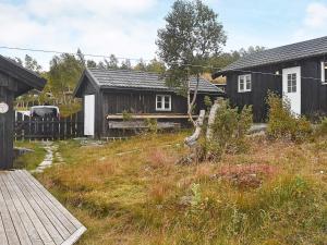 a house with a wooden fence and a yard at 4 star holiday home in Rennebu in Rennebu +48 photos