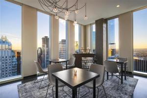 a restaurant with tables and chairs and large windows at Hyatt Centric Congress Avenue Austin in Austin