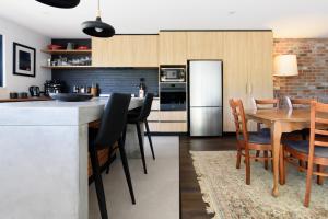 a kitchen and dining room with a table and chairs at Cosy Getaway with outdoor spaces in Launceston