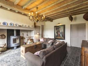 a large living room with couches and a fireplace at Beernem Farmhouse with Pool in Beernem