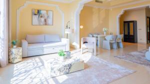a living room with a couch and a table at Al Hamra Residence, RAK in Ras al Khaimah